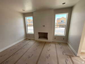 Unfurnished living room featuring a wealth of natural light