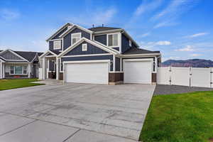 View of front of home with a garage and a front yard