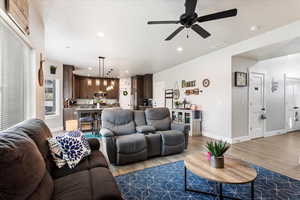 Living room with hardwood / wood-style floors and ceiling fan