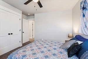 Carpeted bedroom with a closet and ceiling fan