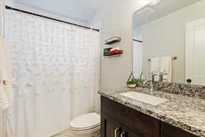 Bathroom with toilet and large vanity