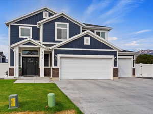 Craftsman-style home with a garage and a front yard