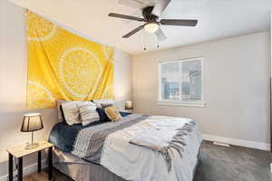 Bedroom with ceiling fan and carpet flooring