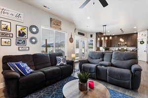 Living room with ceiling fan, french doors, and hardwood / wood-style floors