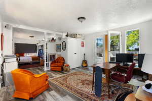 Office space with a textured ceiling and hardwood / wood-style floors