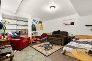 Living room featuring hardwood / wood-style flooring, built in features, and a textured ceiling