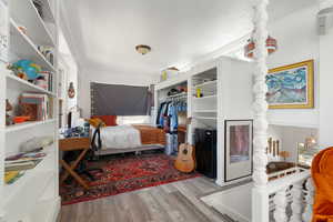 Bedroom featuring wood-type flooring and a closet