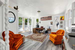 Living room with hardwood / wood-style floors and a textured ceiling