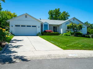 View of front of home featuring a garage and a front yard