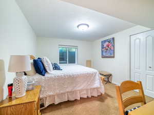 Bedroom with carpet and a closet