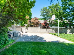 View of yard featuring basketball hoop