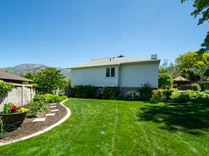 West side of property with a yard and a mountain view