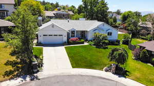 View of front of house with a garage and a front yard