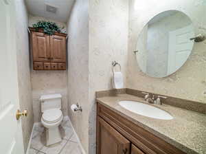 Bathroom with tile flooring, oversized vanity, and toilet