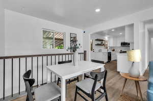 Dining space featuring sink and light hardwood / wood-style floors