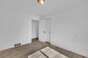 Unfurnished bedroom featuring wood-type flooring