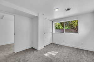 Spare room with carpet floors and a textured ceiling