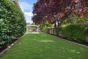 View of yard featuring a  louvered pergola looking south