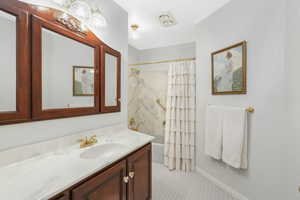 Bathroom 2 featuring tile floors, shower / bath combo, and oversized vanity