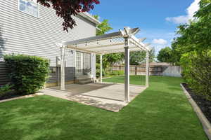 View of landscaped yard with a pergola and a patio area