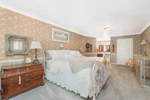 Owner suite with crown molding, walk-in closet and carpet