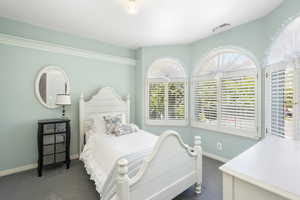 Bedroom #2 featuring dark carpet, natural light