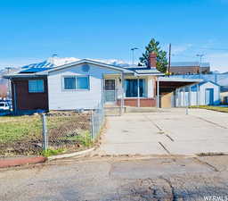 Single story home featuring a carport