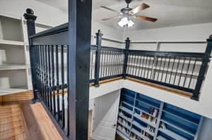 Interior space with ceiling fan and hardwood / wood-style floors