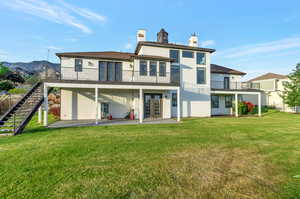 Back of house featuring a patio area, french doors, and a lawn