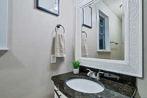 Bathroom featuring vanity with extensive cabinet space