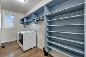 Washroom with washer and dryer, washer hookup, and dark hardwood / wood-style floors