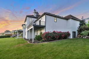 Property exterior at dusk with a yard