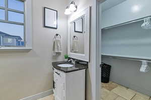 Bathroom featuring oversized vanity and tile floors