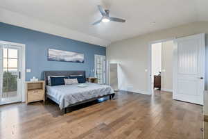 Bedroom featuring ceiling fan, vaulted ceiling, hardwood / wood-style floors, and access to outside