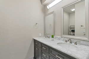 Bathroom featuring dual bowl vanity