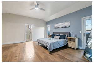 Bedroom featuring multiple windows, ceiling fan, hardwood / wood-style flooring, and lofted ceiling