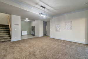 Empty room featuring carpet and ornamental molding