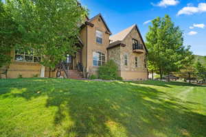 Rear view of property with a lawn