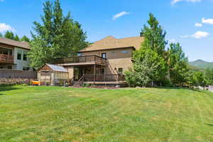 View of yard featuring a wooden deck and an outdoor structure