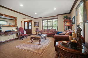 Living room with carpet floors and crown molding