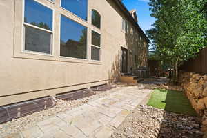 View of side of home featuring a patio area