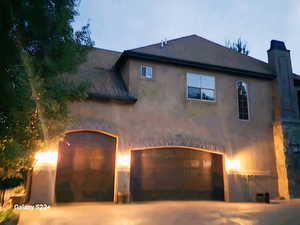 View of property exterior featuring a garage