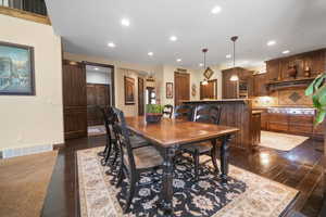 Dining area with dark hardwood / wood-style flooring