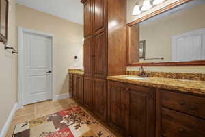 Bathroom with vanity and tile floors