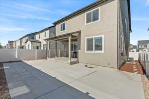 Rear view of house with a patio area and central AC unit