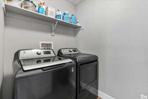 Laundry room featuring washer and dryer and hookup for a washing machine