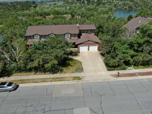 Birds eye view of property with a water view