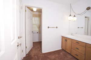 Bathroom with vanity with extensive cabinet space