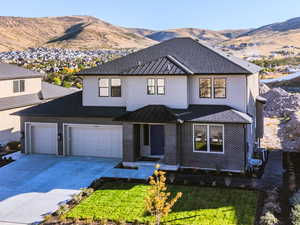 View of front facade featuring a garage and a mountain view