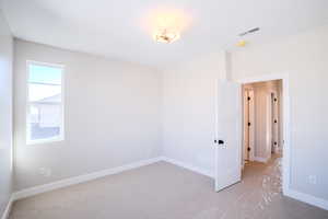 Unfurnished room with light colored carpet